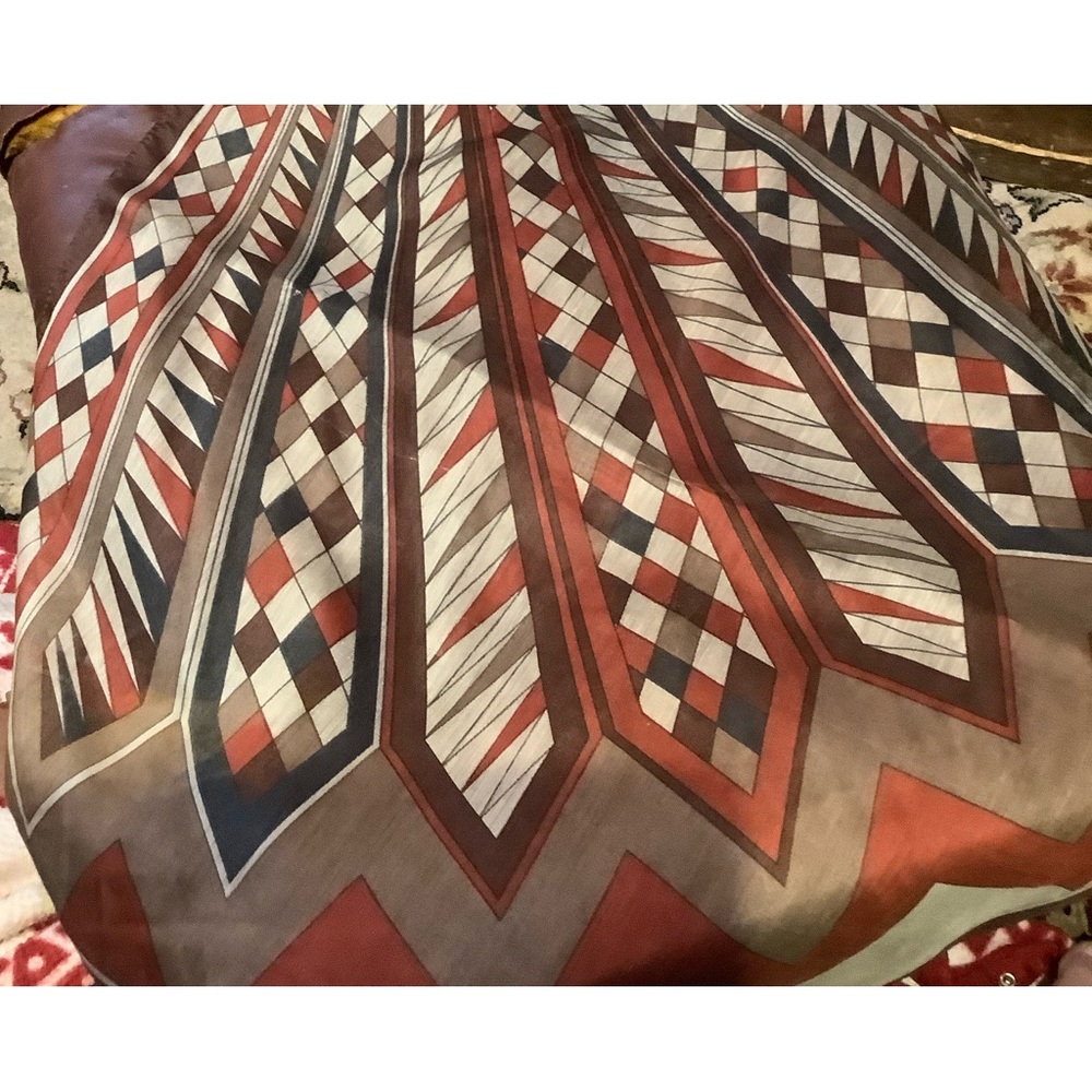 A 23” square scarf with a somewhat western motif,soft but not silk